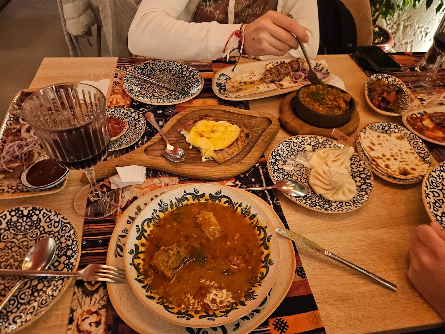 Traditional Moldovan feast with hand-pinched pastries and baked goods on rustic wooden table
