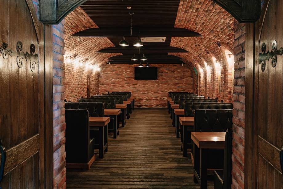 Brick-lined restaurant interior with wooden tables and ambient lighting