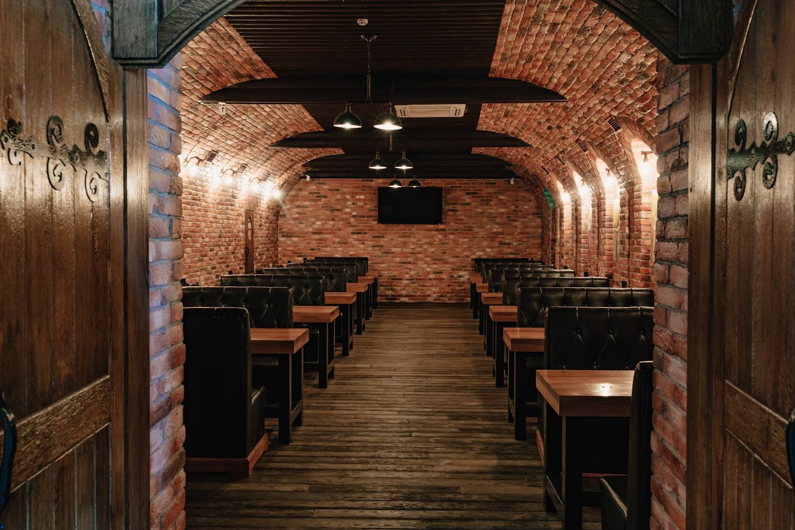 Brick-lined restaurant interior with wooden tables and ambient lighting