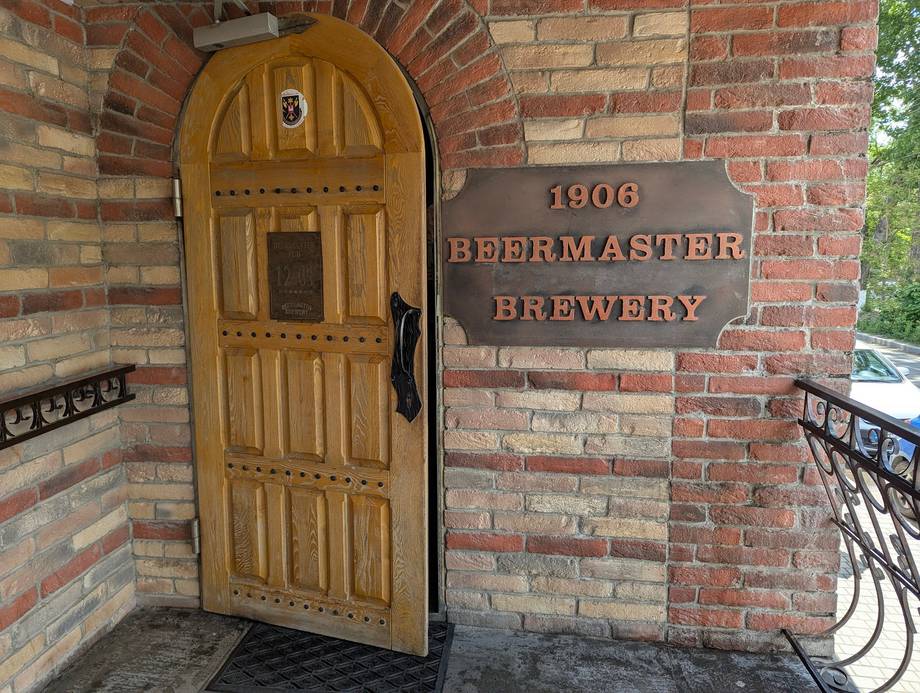 1906 Breermaster Brewery entrance with wooden arched door and historic brick facade