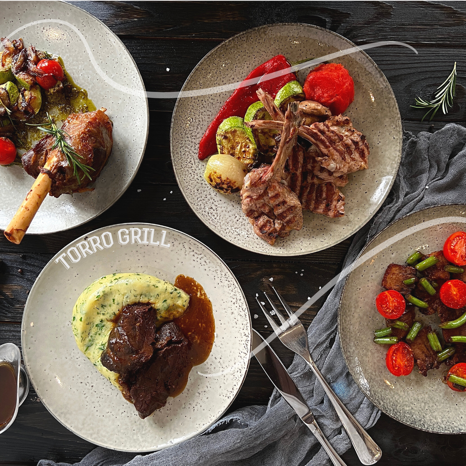 Torro Grill plated meat and vegetable dishes arranged on dining table