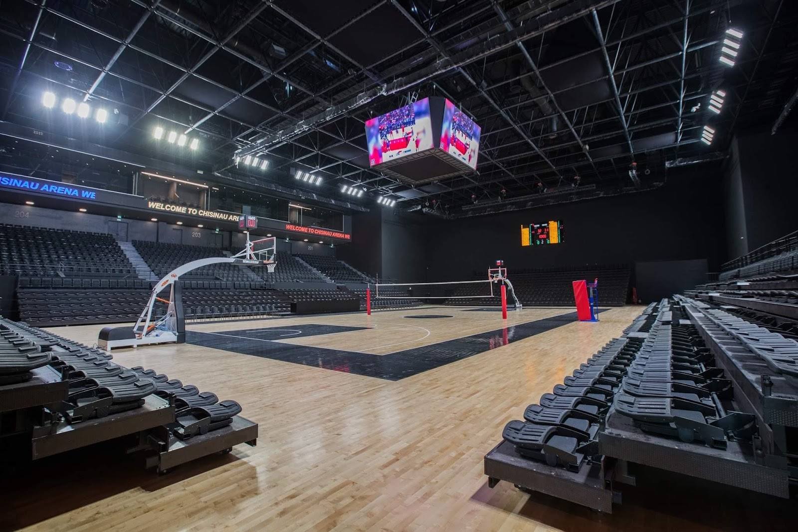 Professional indoor basketball arena with court, scoreboard and seating