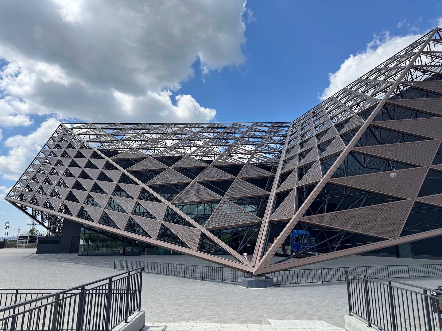 Modern architectural venue with distinctive tilted geometric facade and open plaza