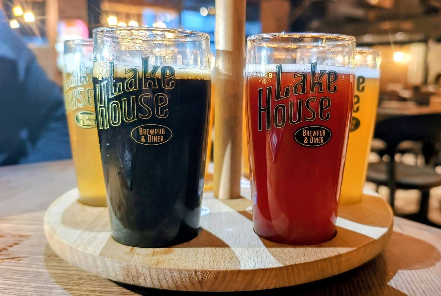 Craft beer flight with branded glasses at Mojo House bar