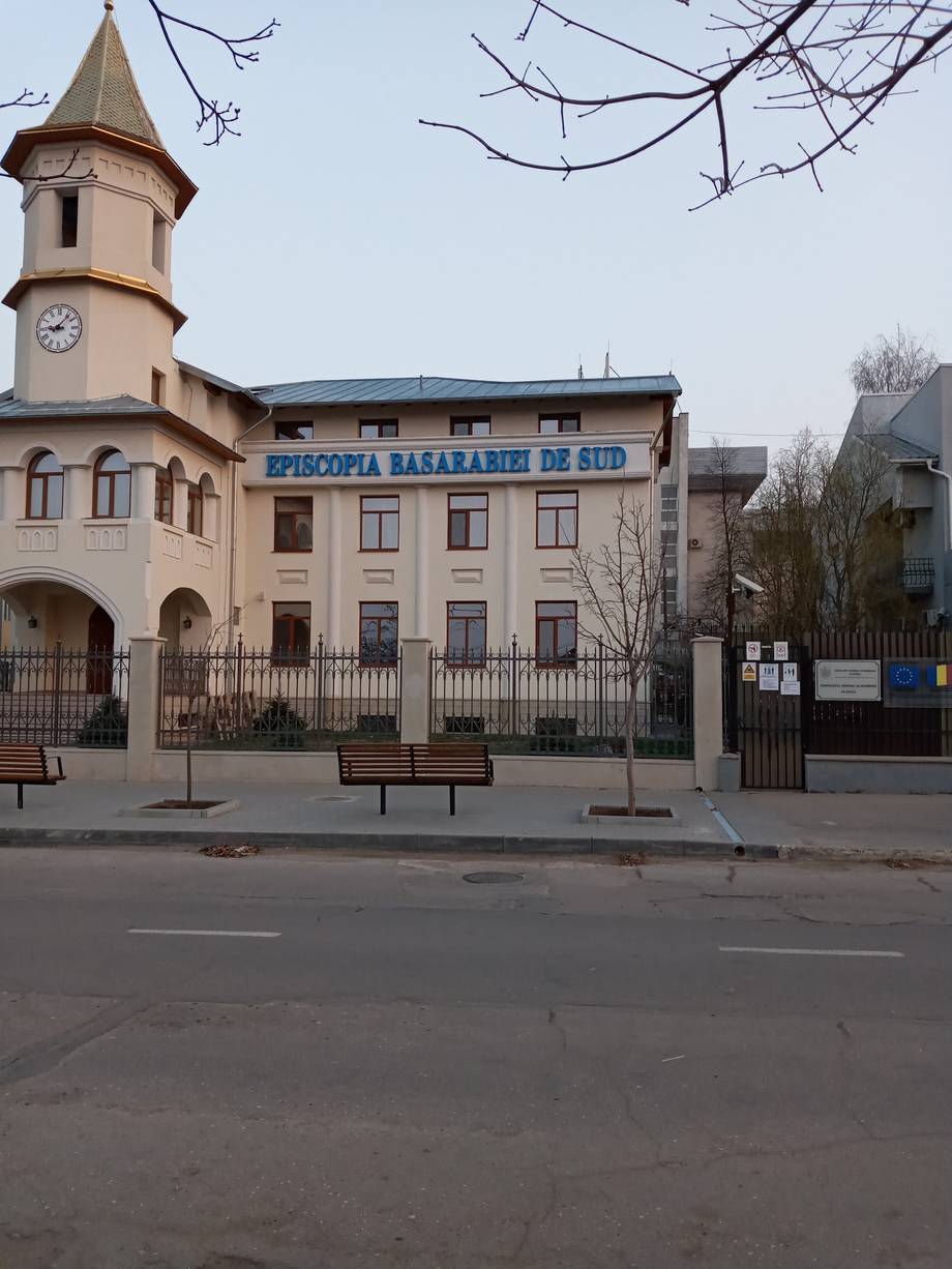 Historic religious building with distinctive tower and blue signage, Sudak Moldova