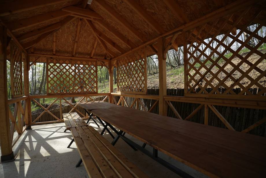 Wooden pavilion terrace with lattice privacy screens and bench seating