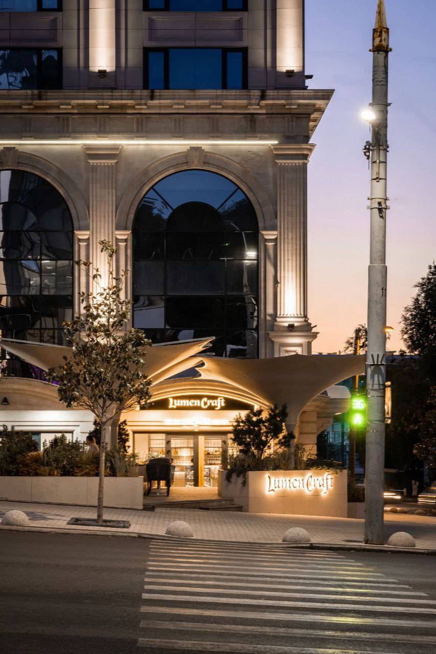 JimmyCreft storefront at dusk with illuminated signage and historic architecture