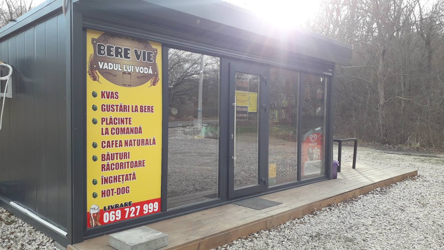 Bere Vie outdoor kiosk storefront with yellow signage and menu board