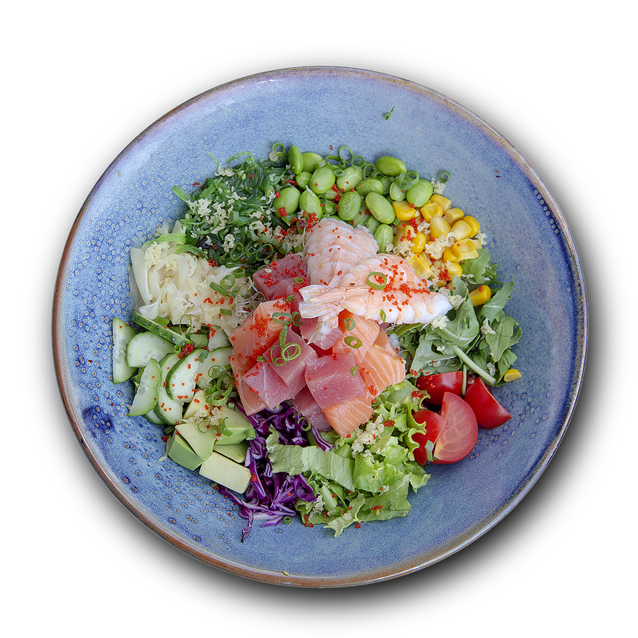 Colorful salad bowl with fresh vegetables, greens, and prosciutto on blue ceramic plate