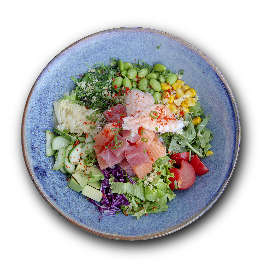 Colorful salad bowl with fresh vegetables, greens, and prosciutto on blue ceramic plate