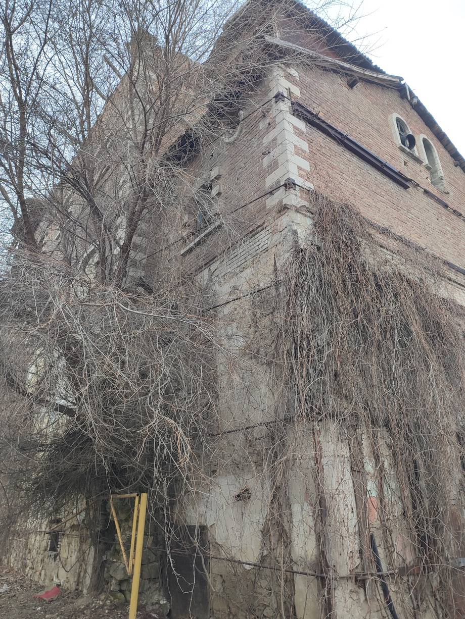 Historic brick fortress tower exterior with bare winter trees