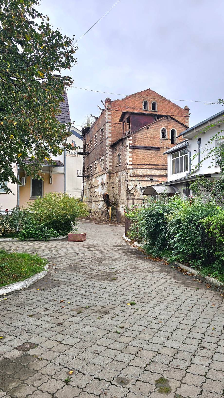 Historic brick monastery with church dome set in courtyard garden