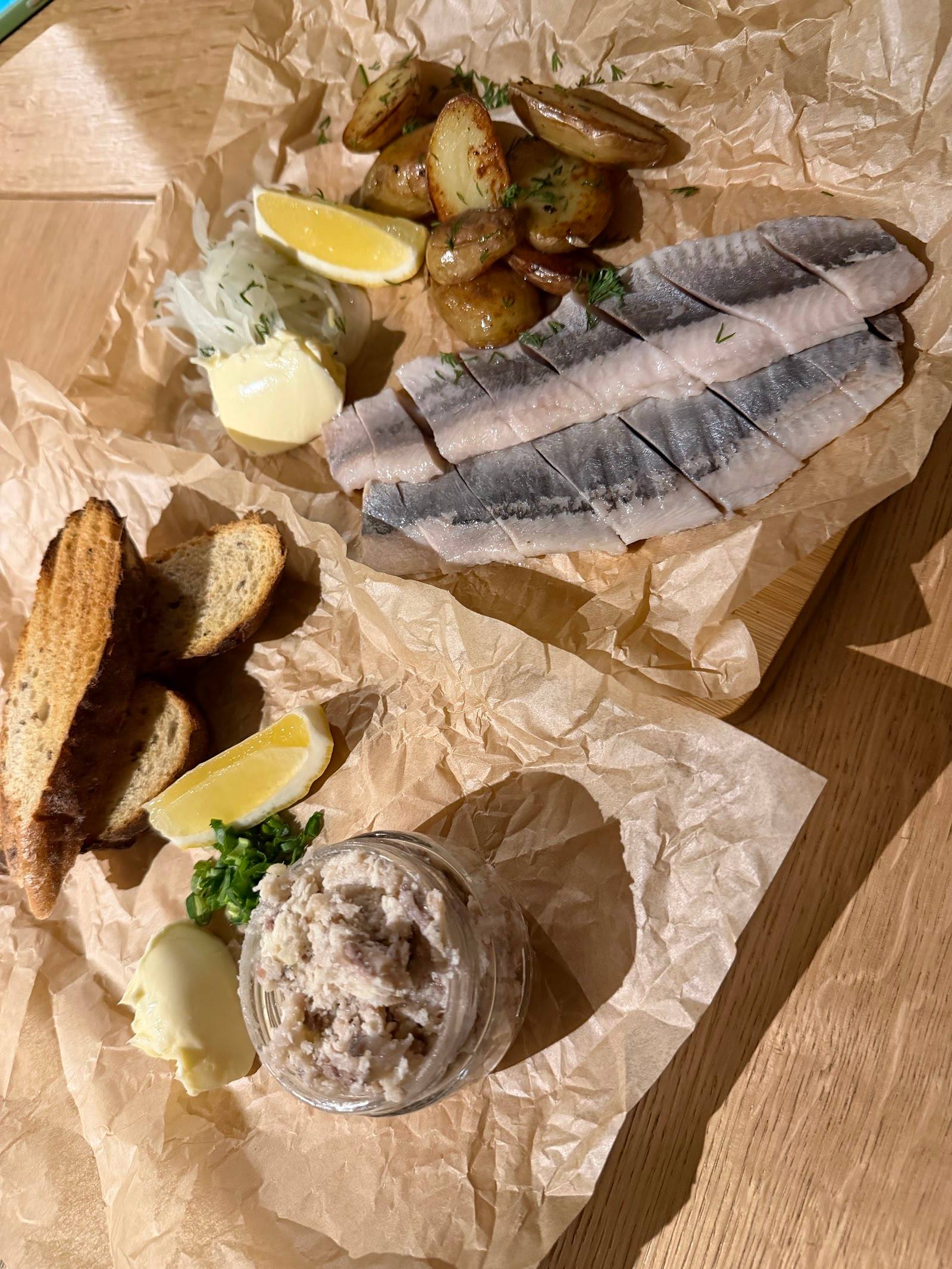 Seafood platter with smoked fish, roasted mushrooms, bread and creamy spread
