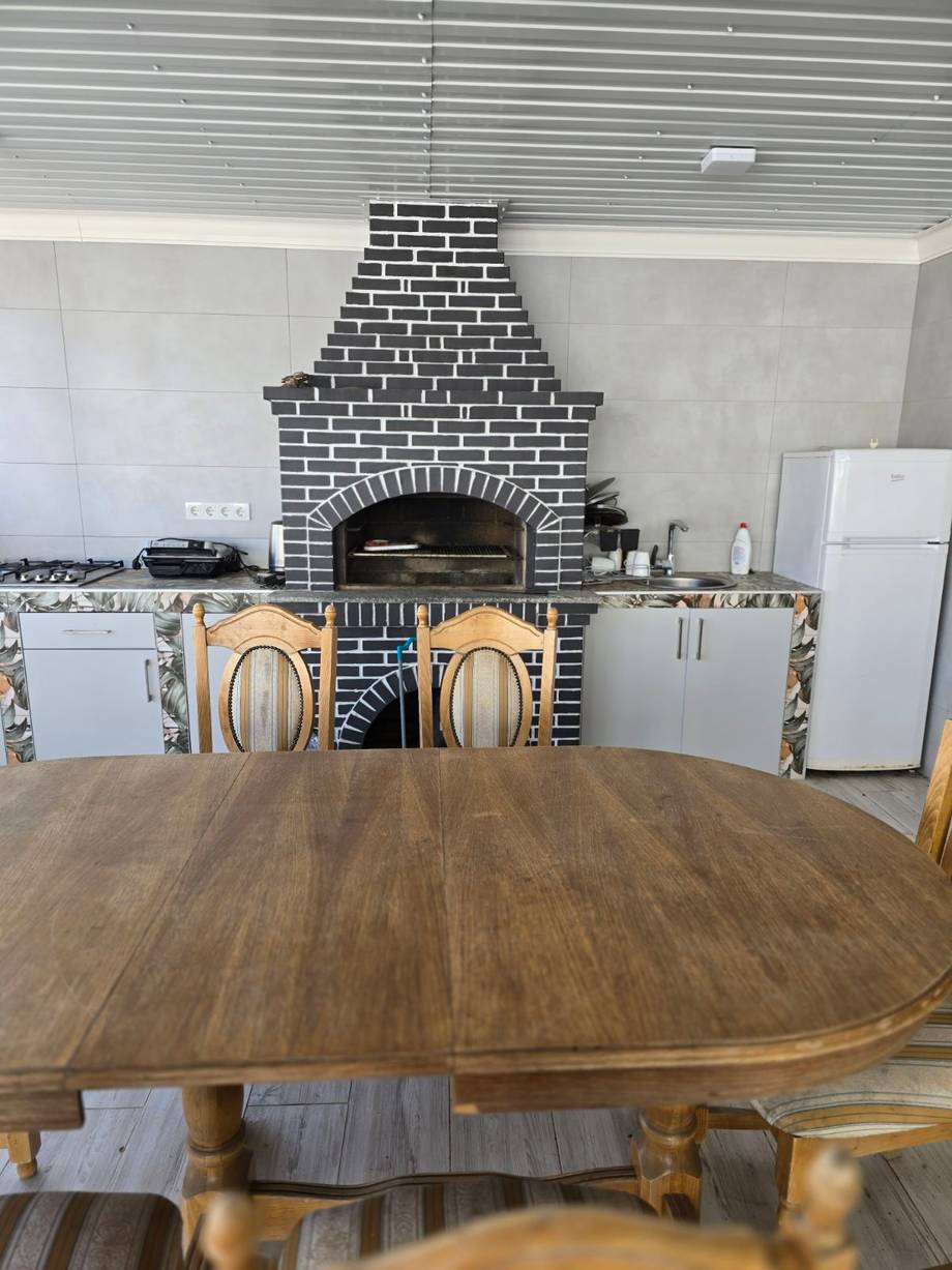 Rustic indoor kitchen and dining space with brick fireplace