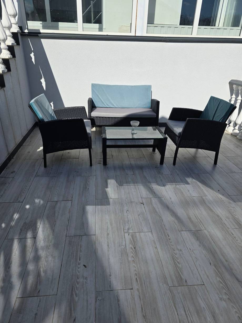 Outdoor terrace seating area with modern furniture and city views
