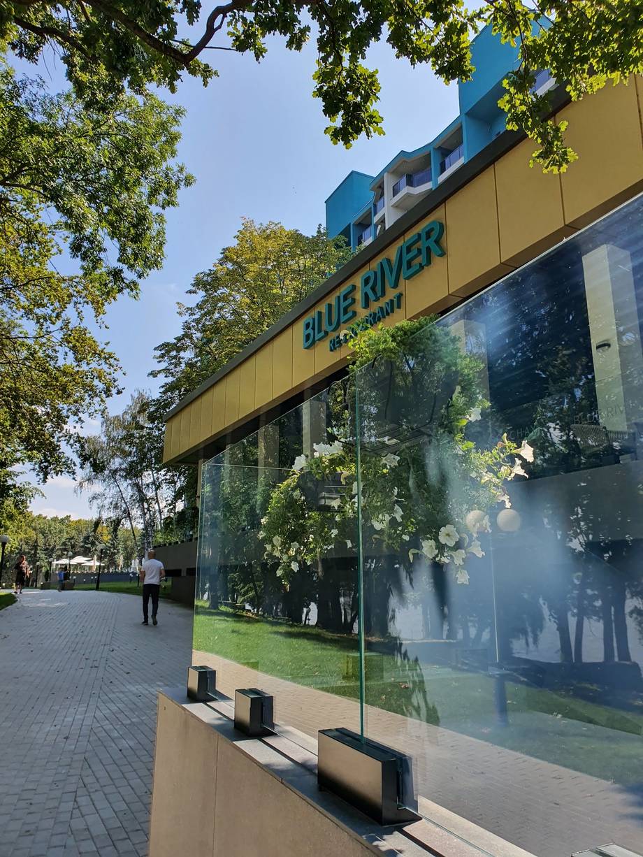 Blue River venue storefront with distinctive yellow-green façade and signage
