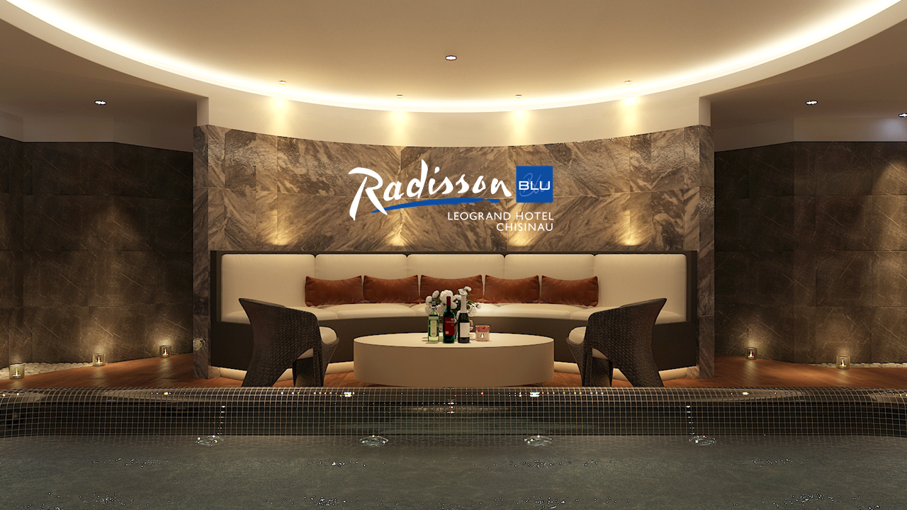Radisson Blu hotel lobby with marble wall, lounge seating, and ambient ceiling lighting