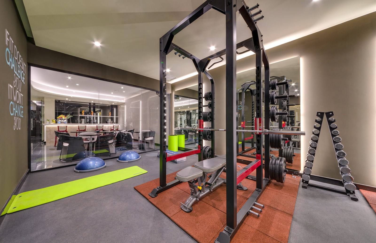 Modern gym interior with strength training equipment and open floor layout