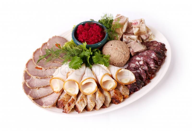 Charcuterie and cold cuts platter with fresh herbs and beetroot sauce