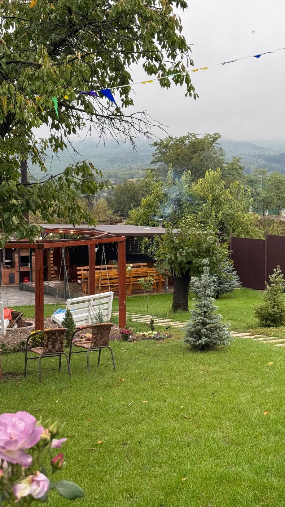 Wooden pergola terrace with panoramic valley views and landscaped gardens