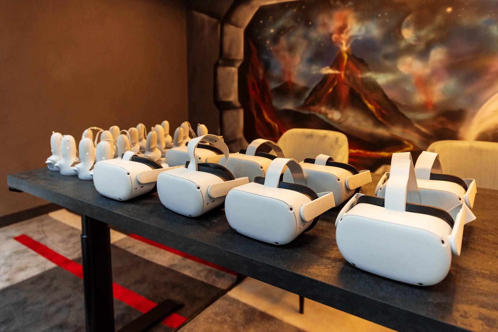VR headsets displayed on table with dramatic volcano mural backdrop
