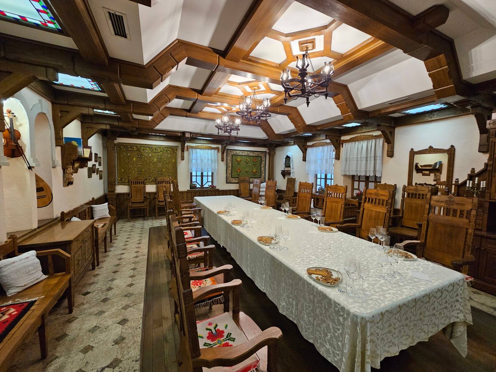 Historic chapel interior with ornate coffered ceiling, wooden furnishings, and altar setup
