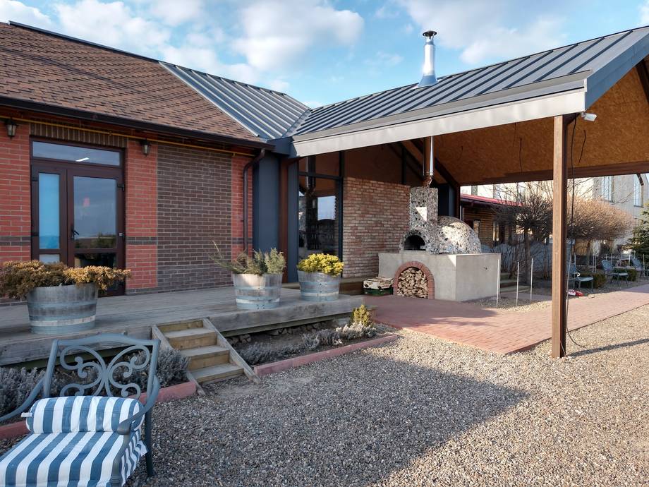 Modern brick venue exterior with covered terrace and courtyard seating area