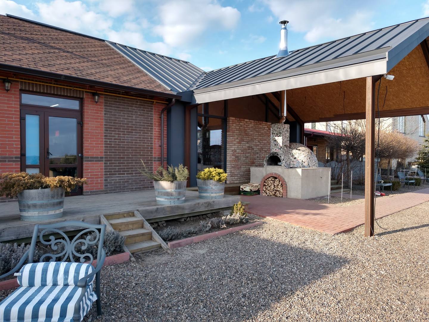 Modern brick venue exterior with covered terrace and courtyard seating area