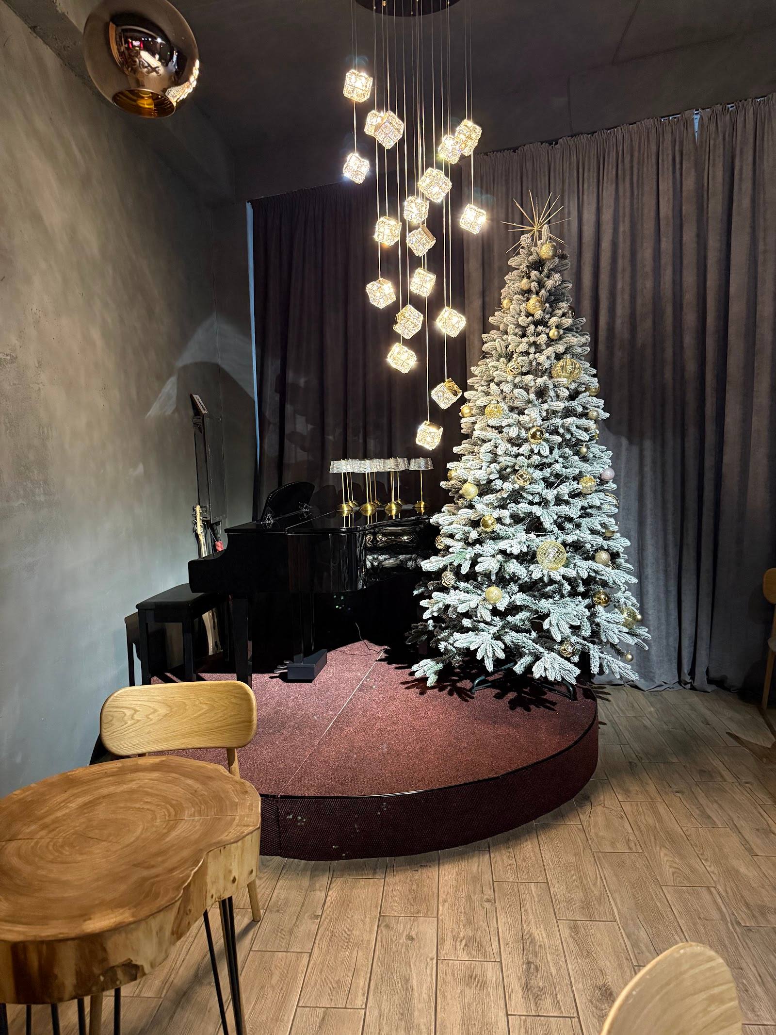 Modern interior with holiday decor, frosted tree, and contemporary pendant lighting