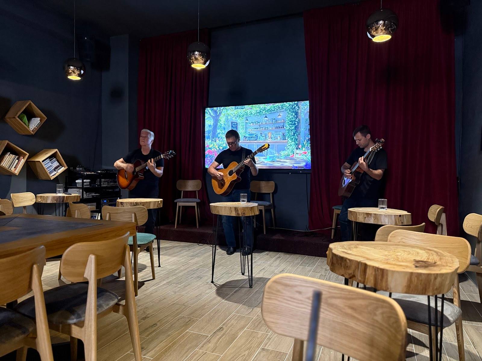 Live band performance in intimate venue with wood tables and ambient lighting