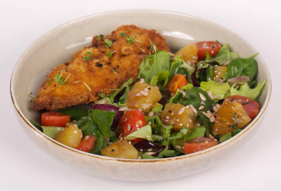 Plated Asian-style chicken and vegetable stir-fry with sesame garnish