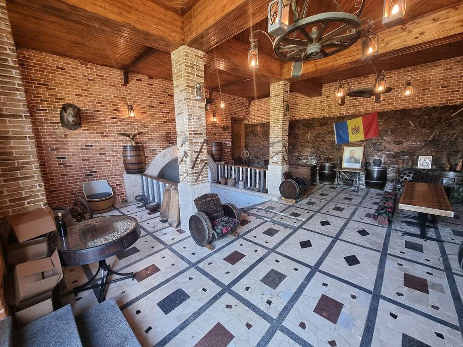 Rustic brick interior with geometric tile flooring and wooden ceiling beams