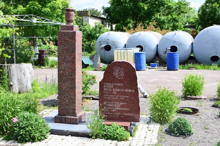 Memorial and blue storage tanks at monastery grounds
