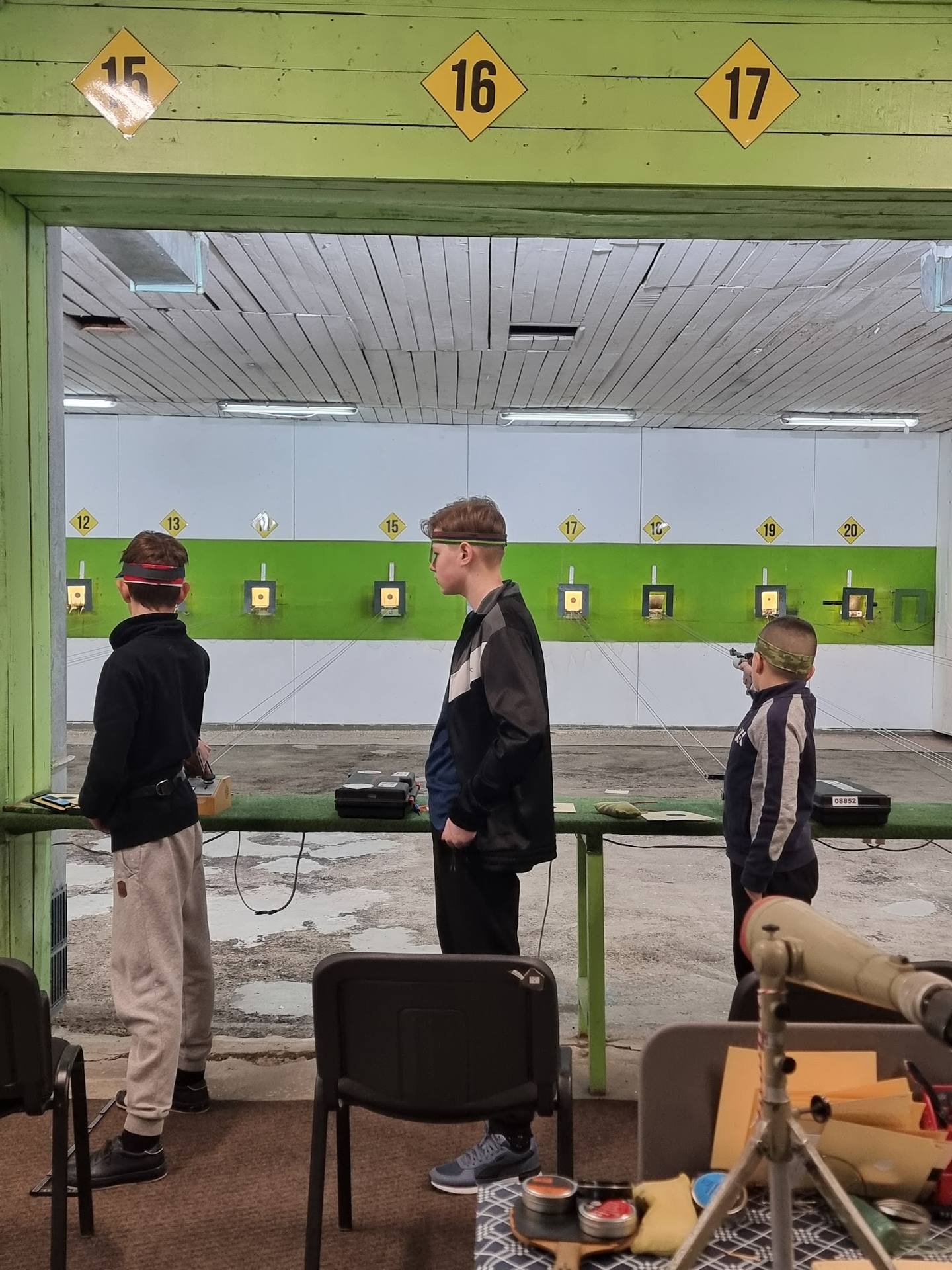 Indoor shooting range with numbered target lanes and safety barriers