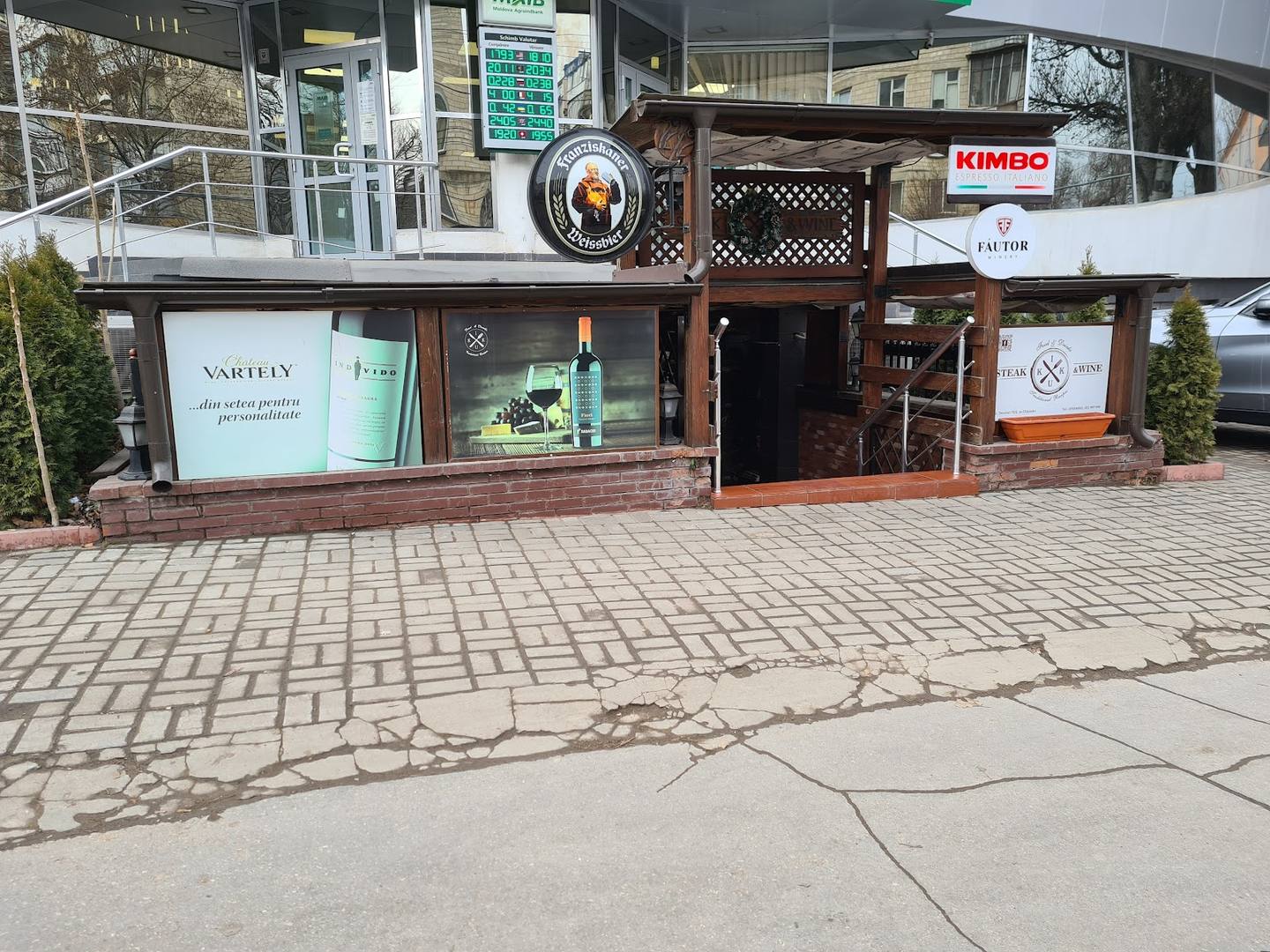 Brown-facade storefront with beer signage and street-level entrance on paved exterior