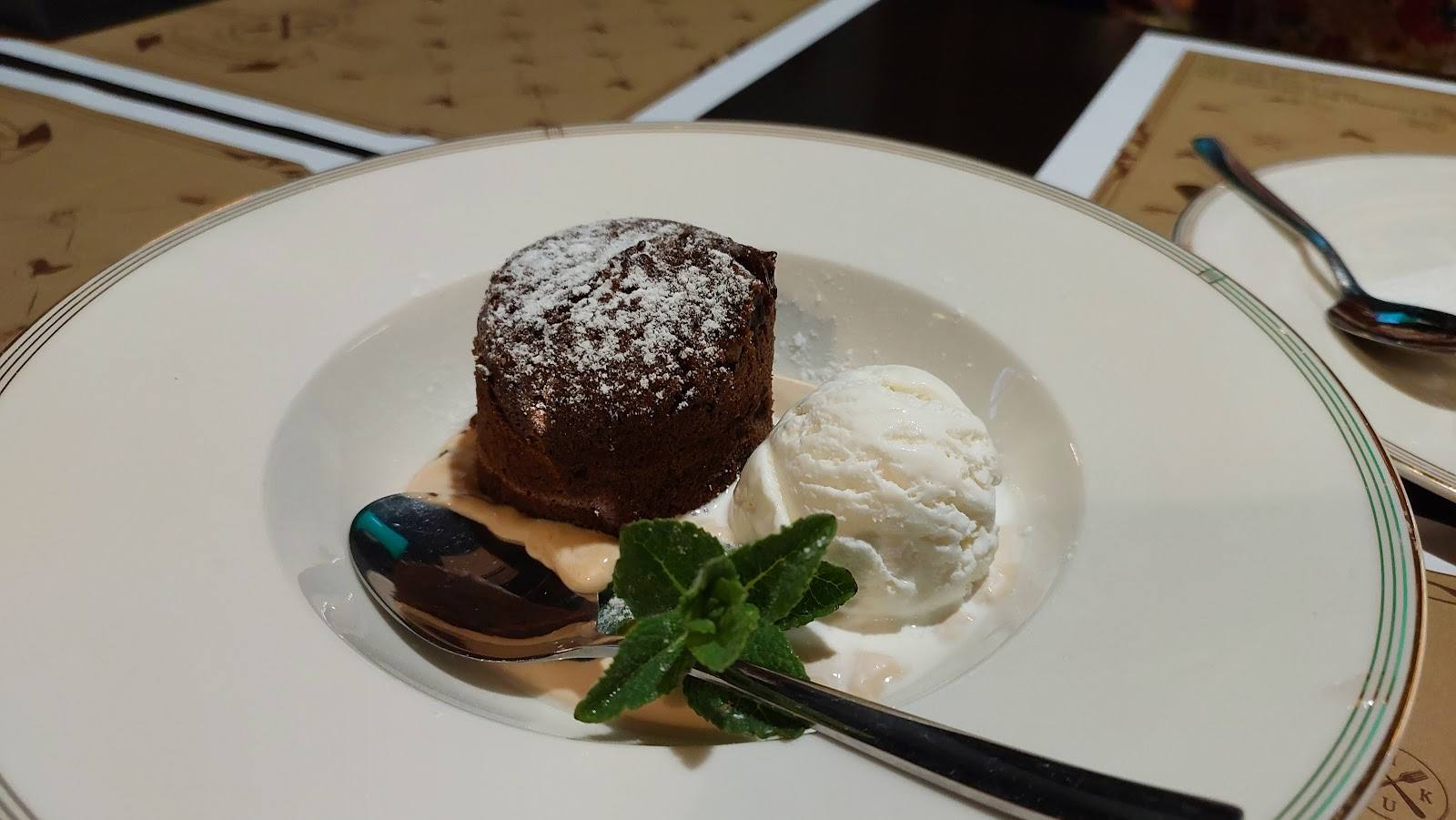 Chocolate molten cake with whipped cream and mussels garnish