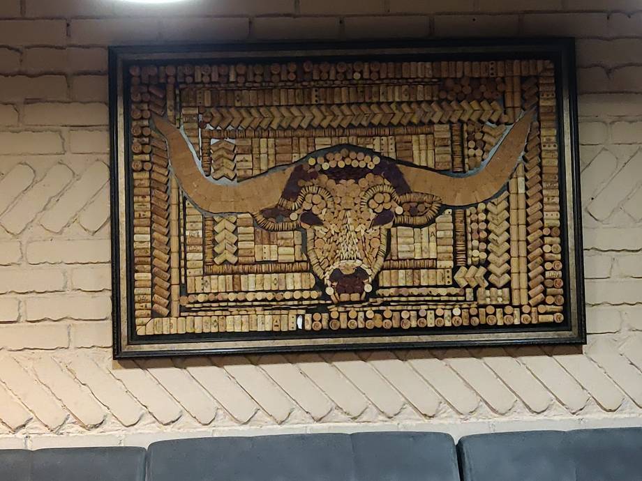 Ornate golden bull head wall artwork with geometric patterns in black frame