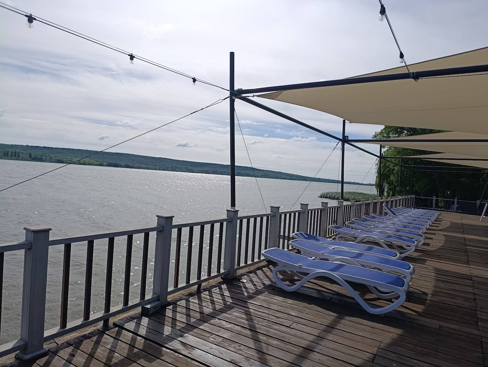 Waterfront terrace with lounge chairs overlooking the Dniester river