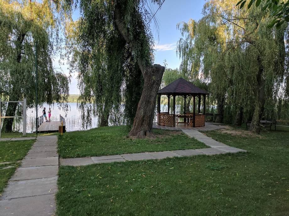 Willow-lined park grounds with covered pavilion and waterfront view