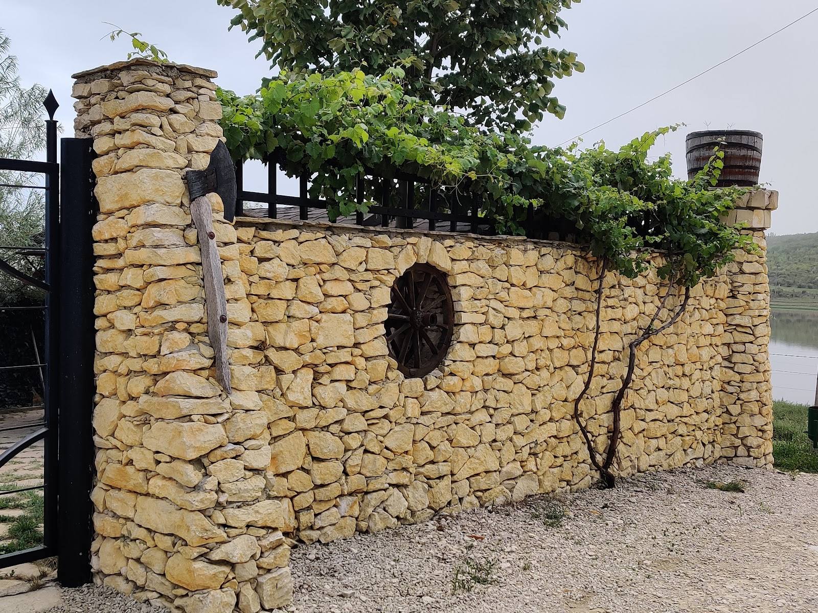 Stone fortress with manicured courtyard and water view backdrop
