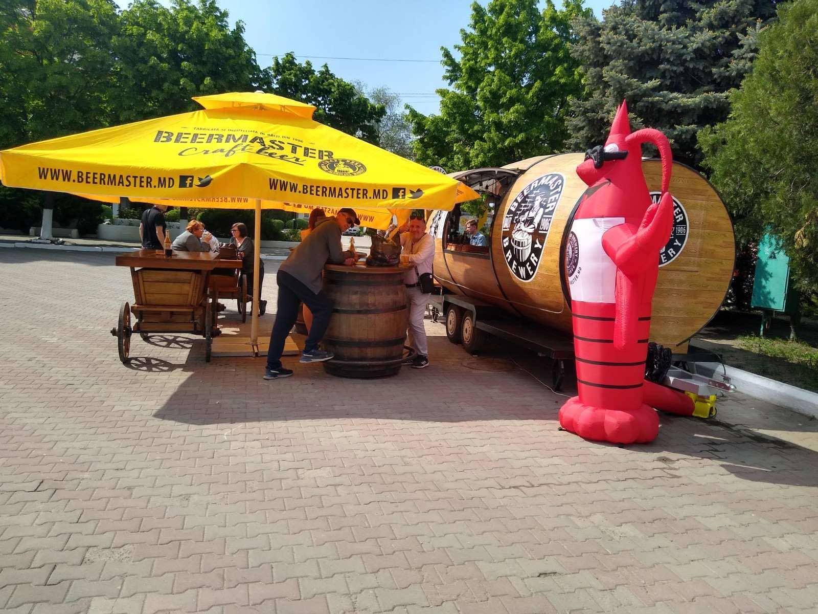 Beer garden exterior with yellow umbrellas and branded installations