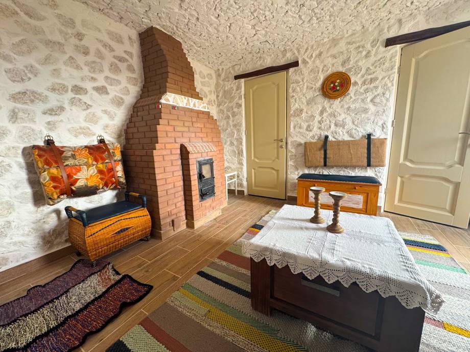 Traditional Moldovan cottage interior with fireplace and period furnishings