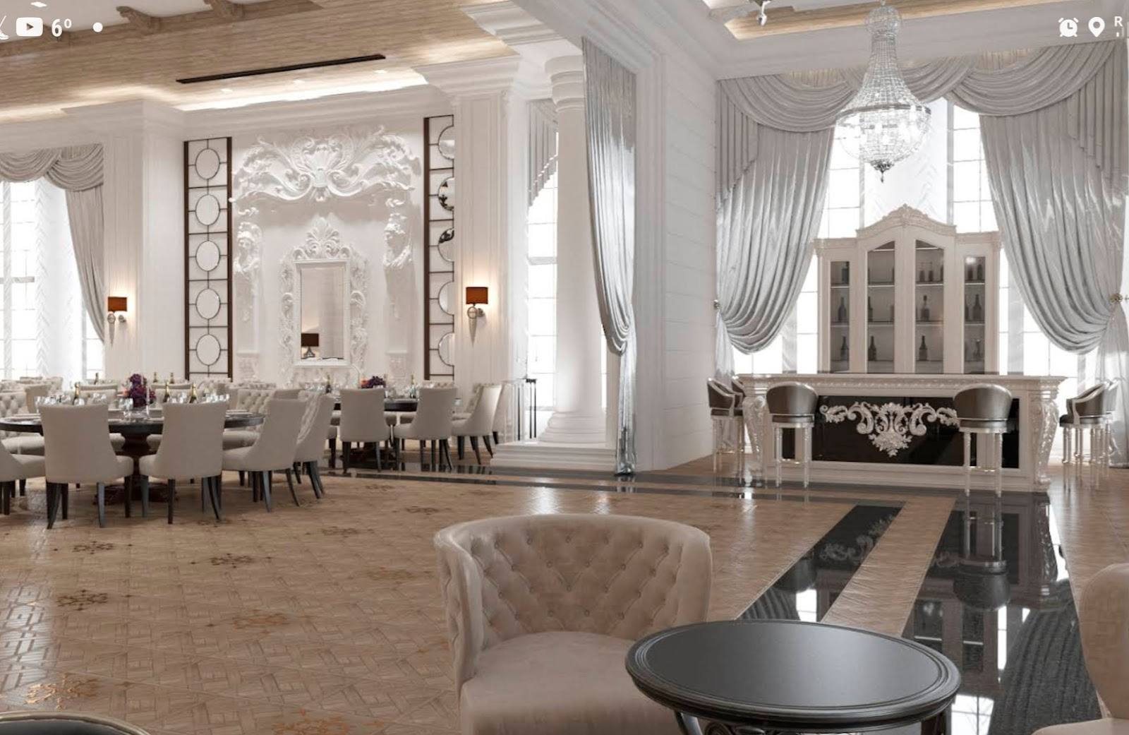 Elegant event hall with soaring ceilings, draped windows, and refined furnishings