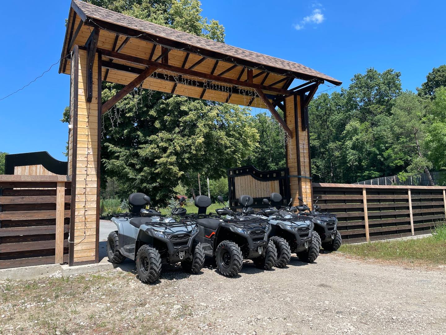 ATV quad bikes parked under covered shelter at activity venue