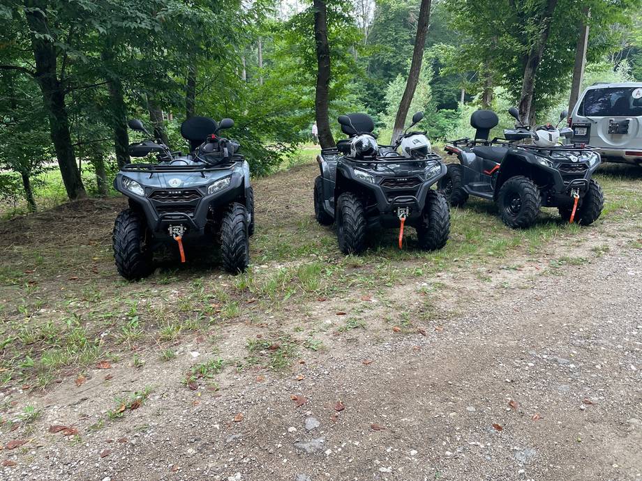 ATV quad bikes parked in forest clearing ready for adventure tours