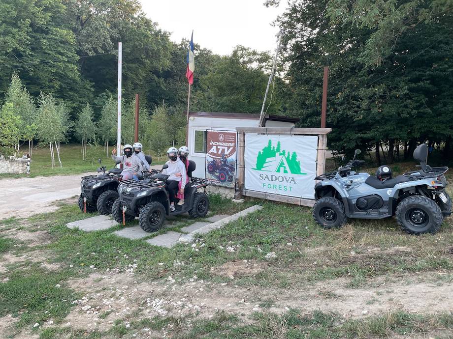 ATV quad bike tour group with guides in a wooded park setting