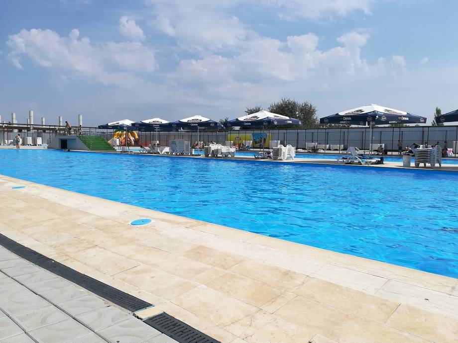 Olympic-style outdoor swimming pool with clear blue water and modern facilities