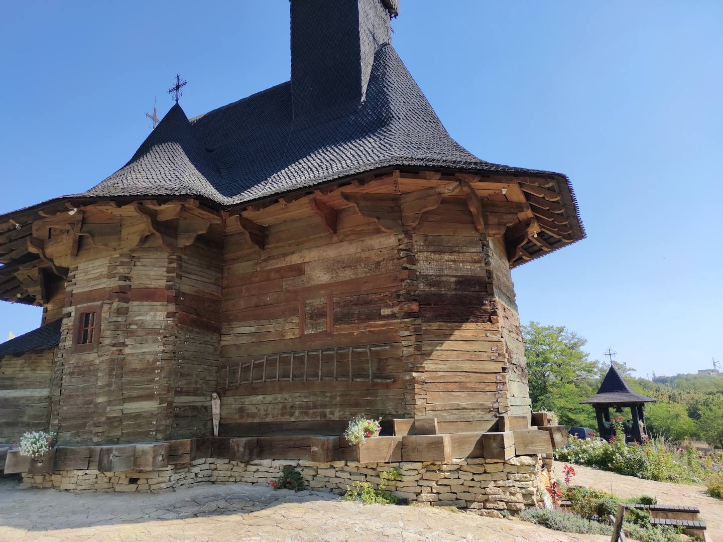 Wooden monastery church with iconic cross-topped spire and traditional architecture