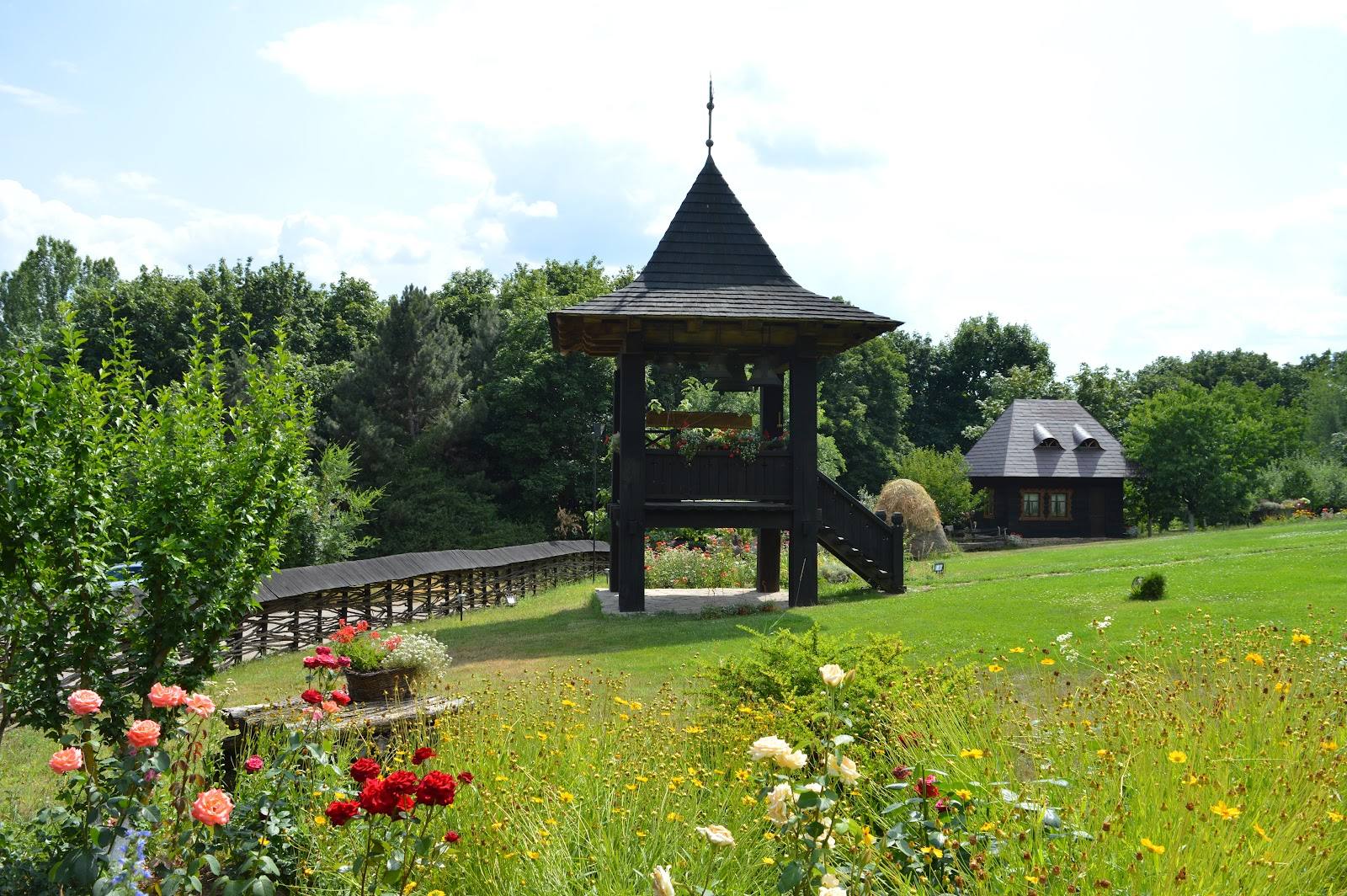Iconic wooden gazebo with manicured grounds and flower beds in rural Moldova estate