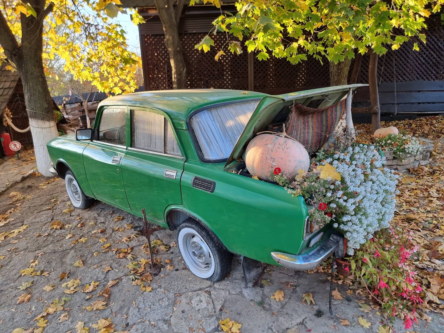 Vintage green car with flowers used as decorative prop installation